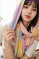 a woman wearing a colorful striped scarf