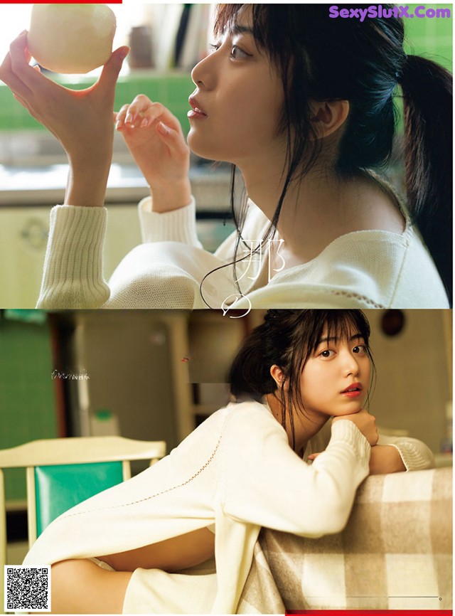 A woman in a white sweater holding an apple in her hand.
