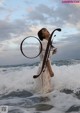 A woman standing in the ocean with the words "Best Omika" written on it.